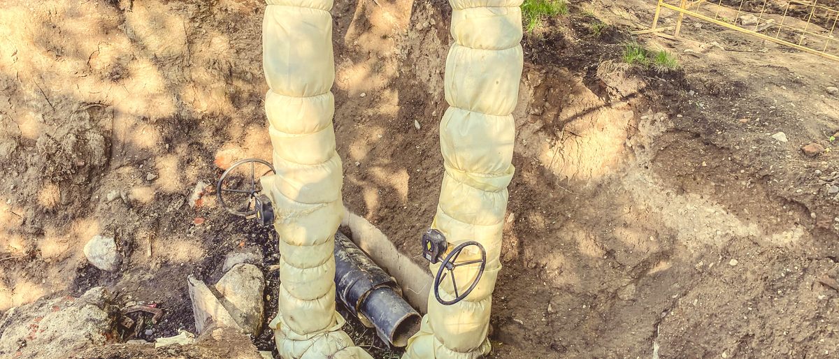 Service pipes in an open trench before backfilling
